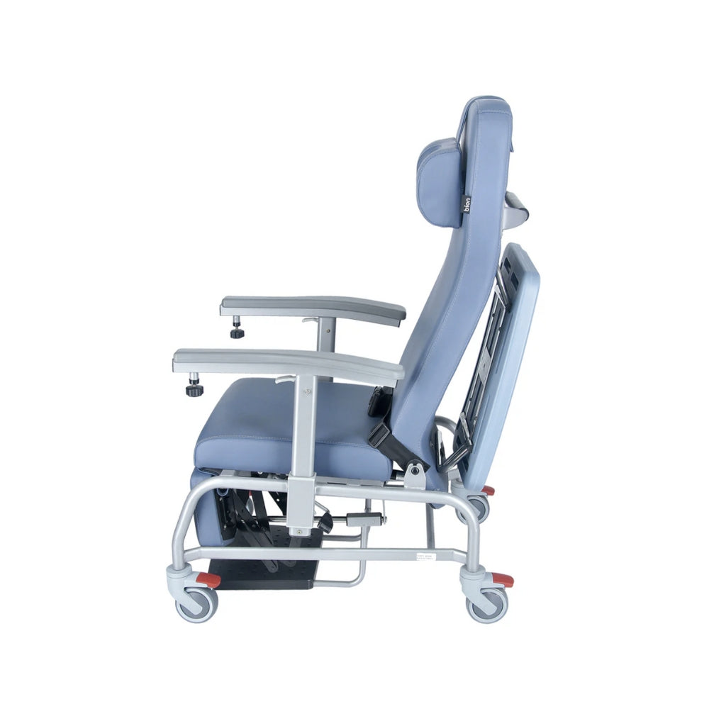 Luxurious cushioned geriatric homecare chair with extended legrest and recliner backrest on a white background. Side View.