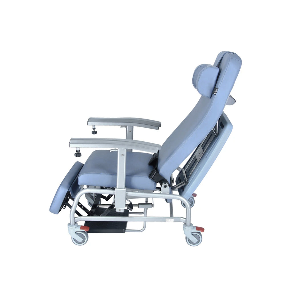 Luxurious cushioned geriatric homecare chair with extended legrest and recliner backrest on a white background. Recline Side View.