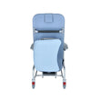 Luxurious cushioned geriatric homecare chair with extended legrest and recliner backrest on a white background. Meal tray stow to the back. 