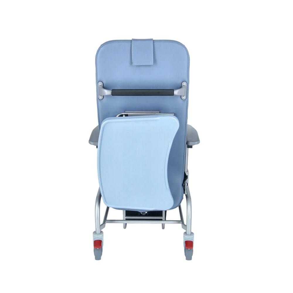 Luxurious cushioned geriatric homecare chair with extended legrest and recliner backrest on a white background. Meal tray stow to the back. 